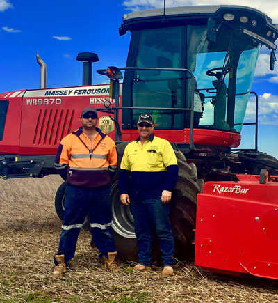 The team at G & J East is standing in front of a Massey Ferguson WR9870